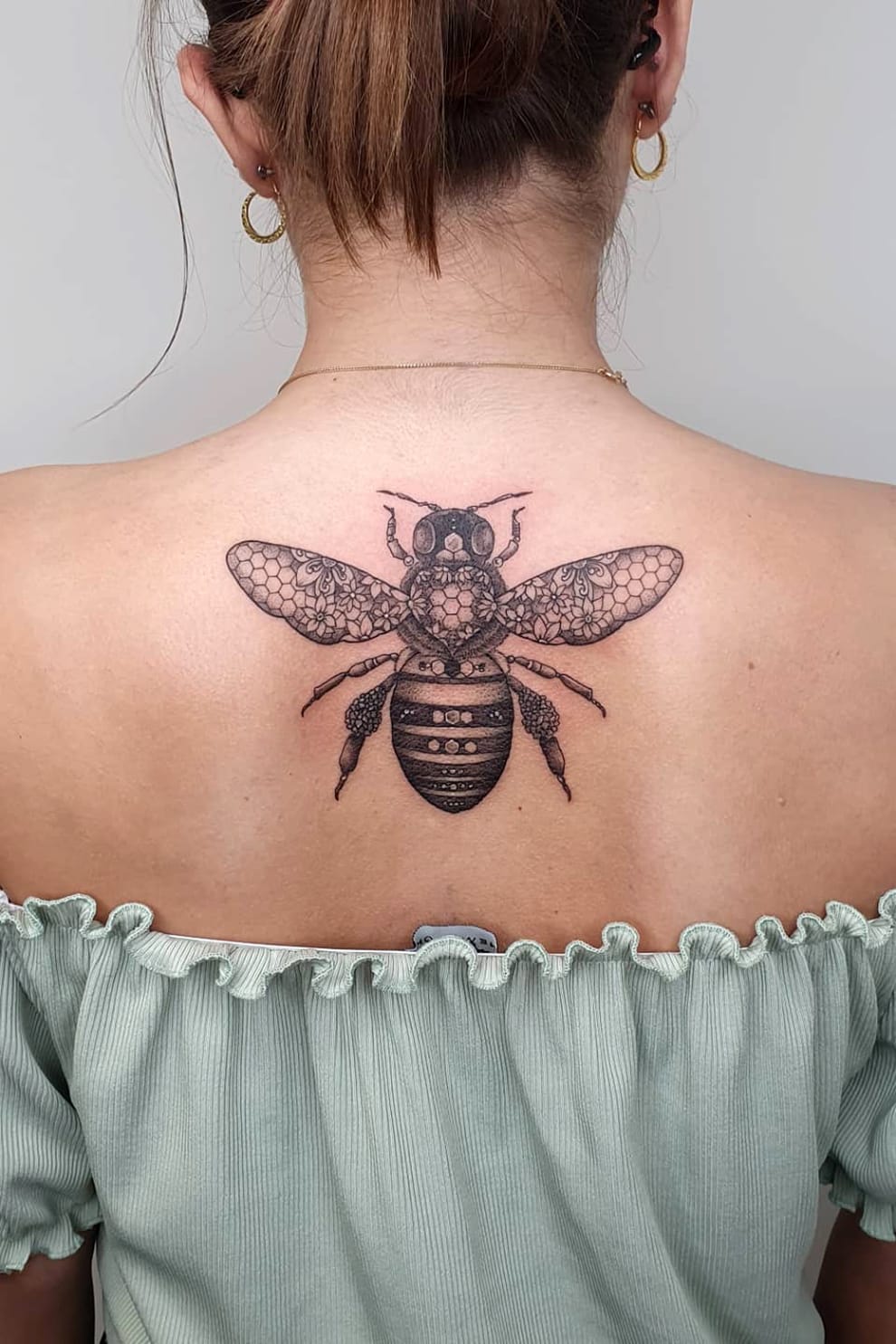 Bee tattoo on back
