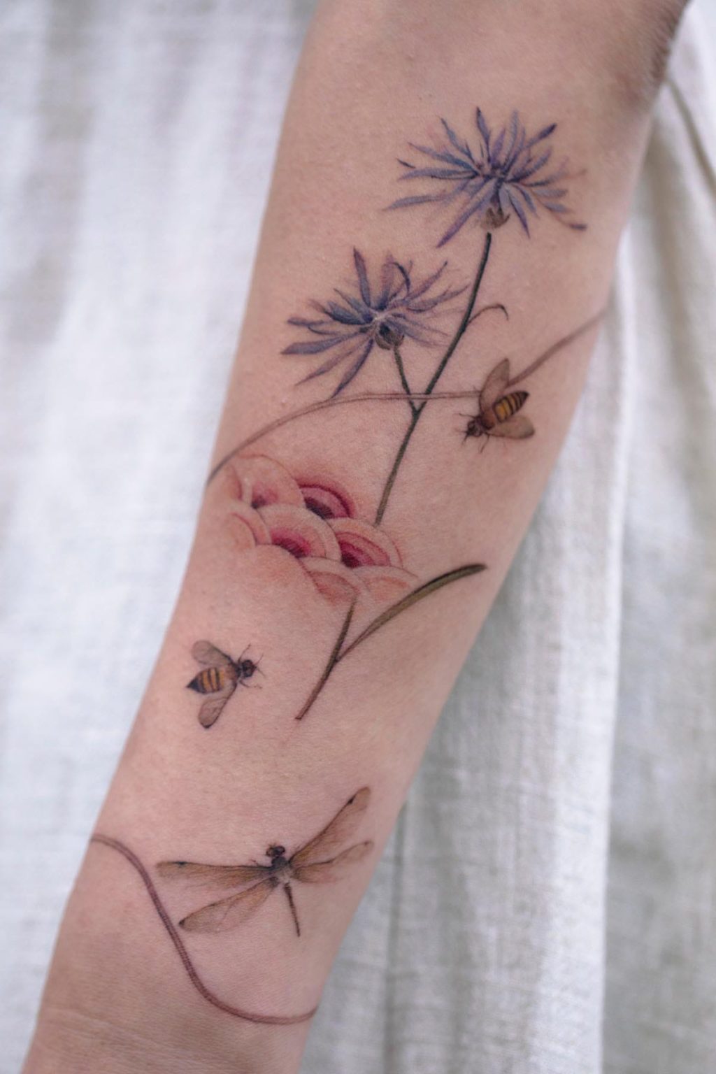 Bee tattoo on forearm