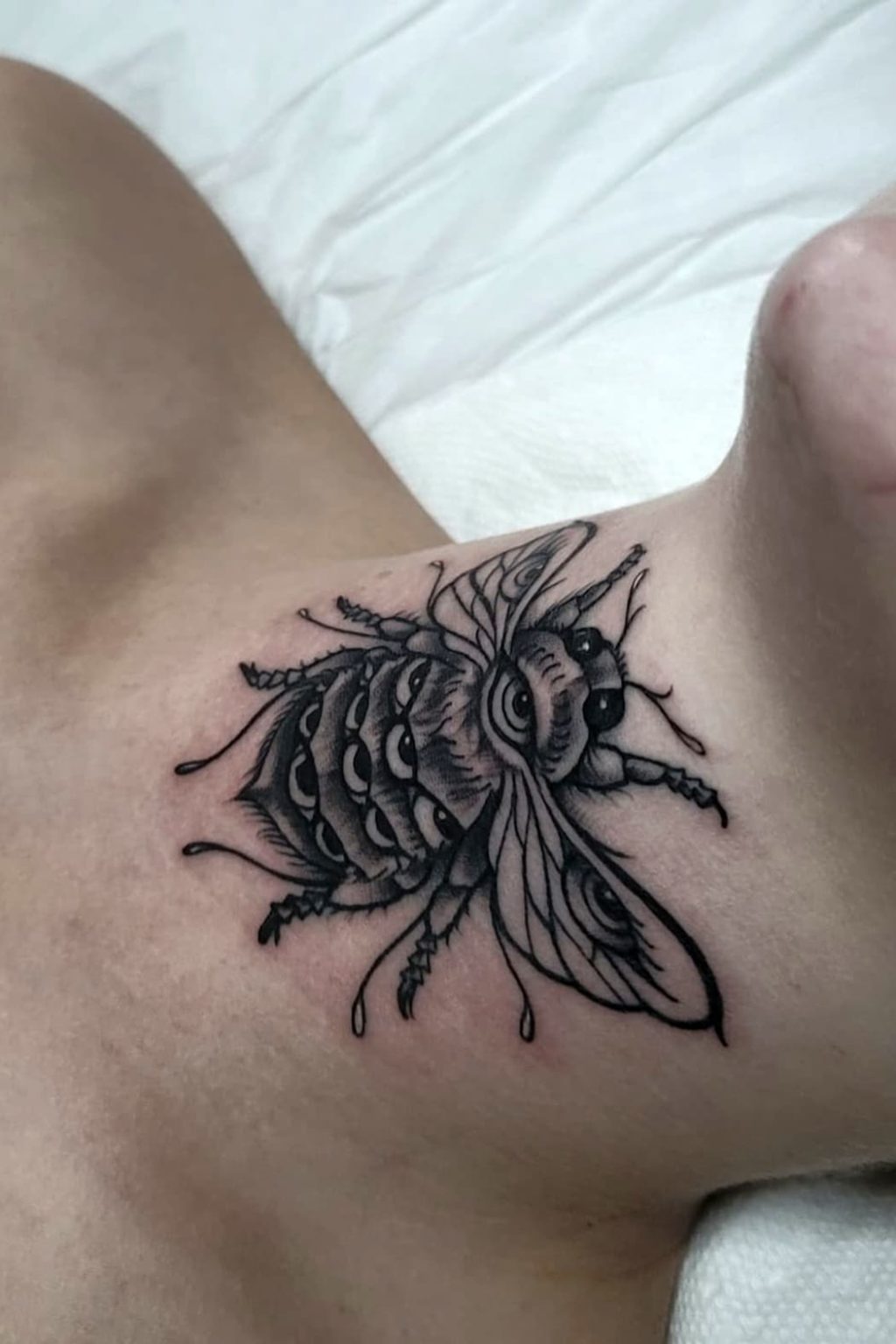 Bee tattoo on neck