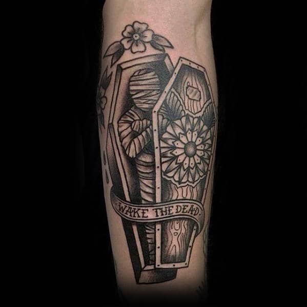 coffin with mummy wake the dead guys outer arm tattoos
