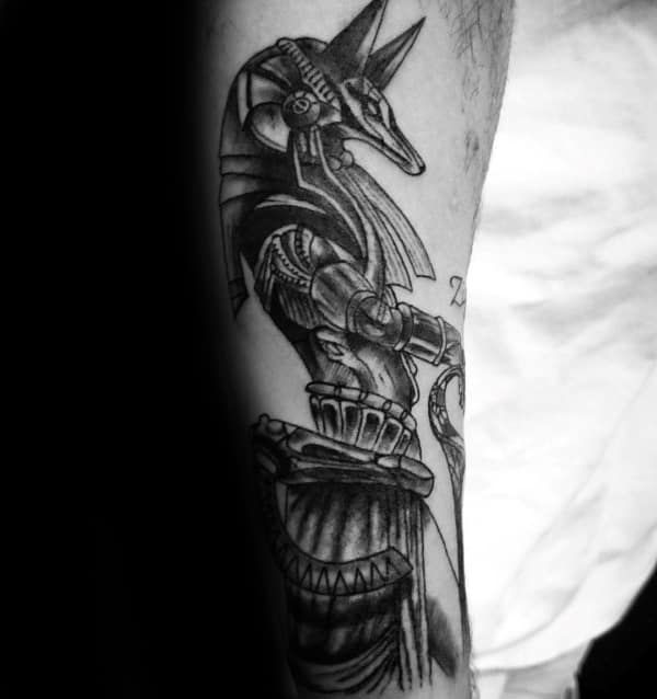 guy with anubis inner forearm tattoo with black ink