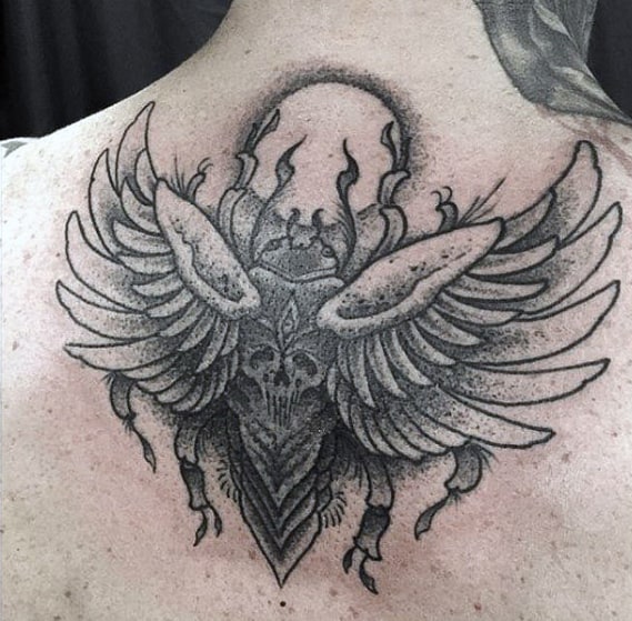 guys black and grey shaded scarab moon upper back tattoo