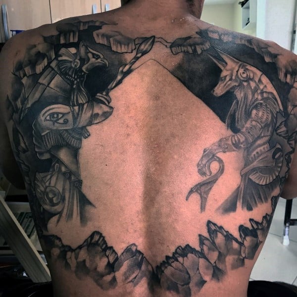 huge pyramid negative space guys anubis tattoo on back