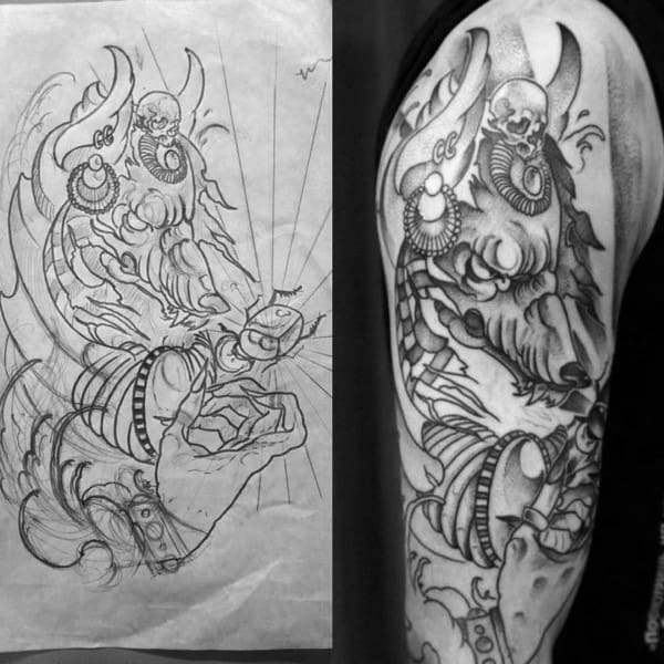 male with anubis upper arm tattoo