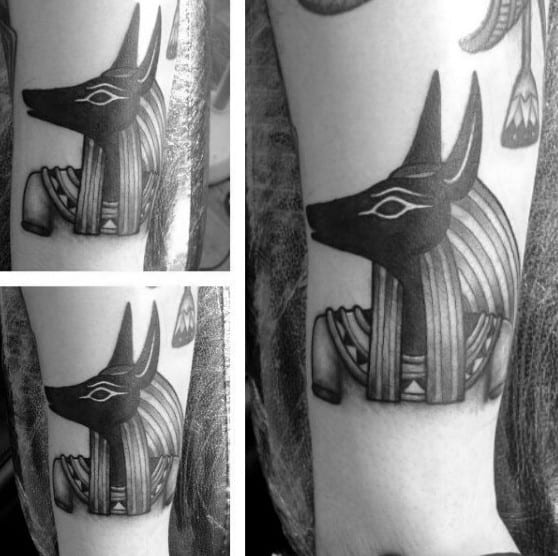 male with small anubis tattoo on arm
