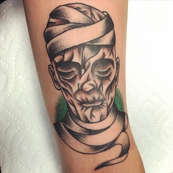 man with cool mummy portrait tattoo on arm