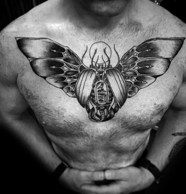 man with masculine scarab bettle tattoo design on chest