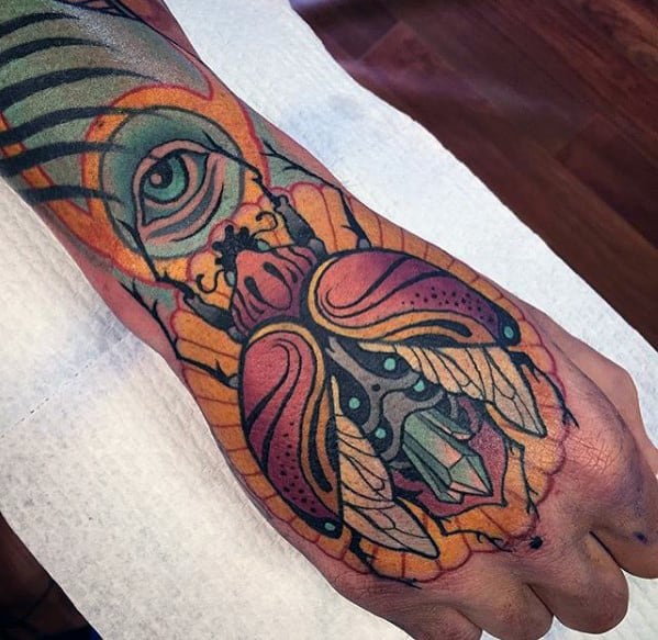 mens neo traditional scarab cystal eye hand and forearm tattoo