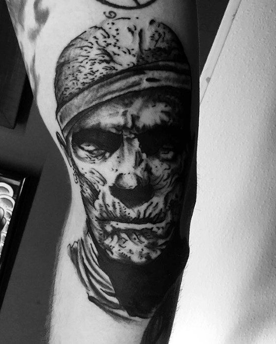 portrait of mummy tattoo on mans arm