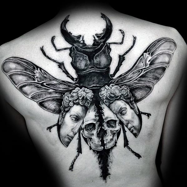 scarab bettle with skull and heads mens back tattoo
