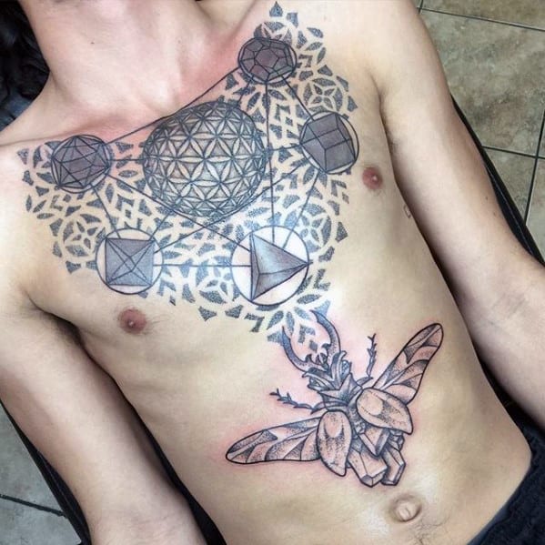 unique geometric scarab bettle male chest tattoo