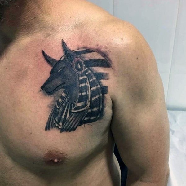 upper chest male with tattoo of anubis god