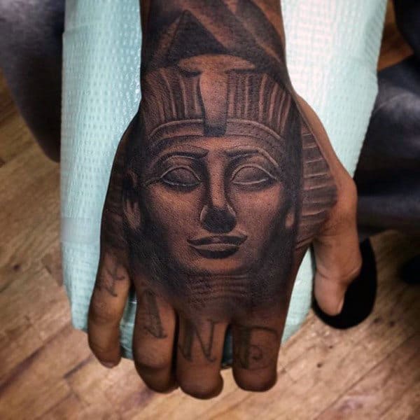 male with king tut shaded hand tattoo