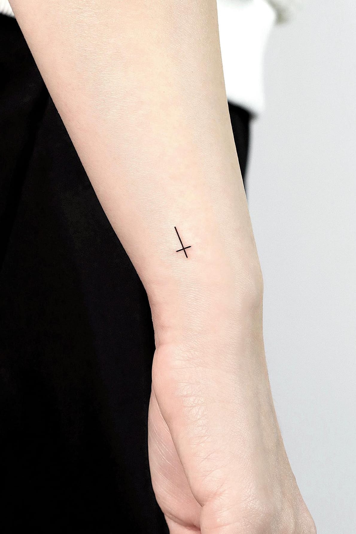 Small Upside Down Cross Tattoo