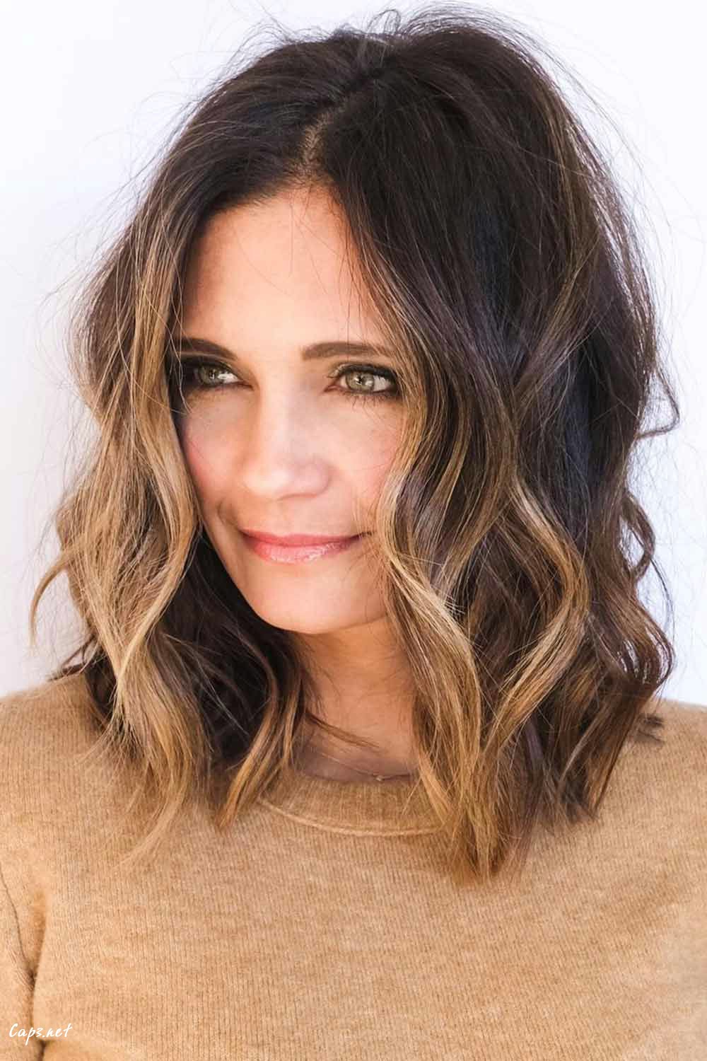 hairstyles for women over 50 new style wavy messy side styling