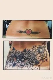 female cover up flower tattoo on lower back