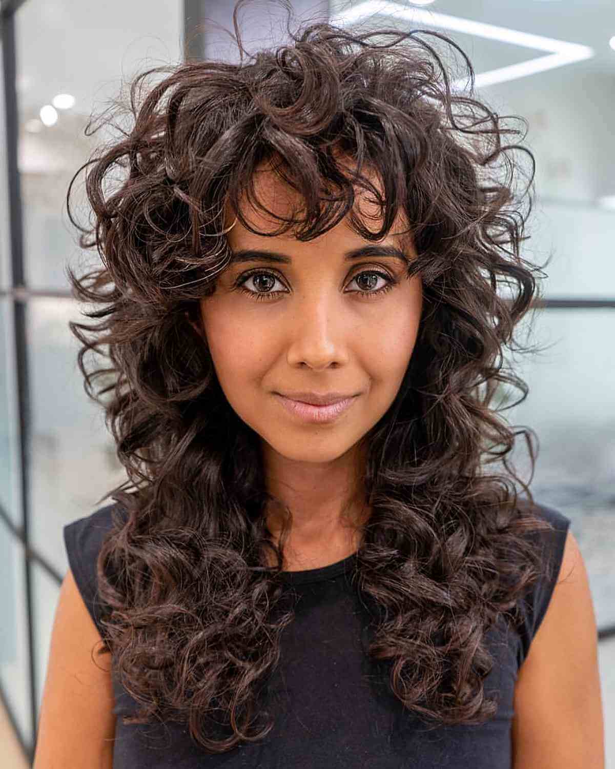 long curly shag with curly bangs on women over 40