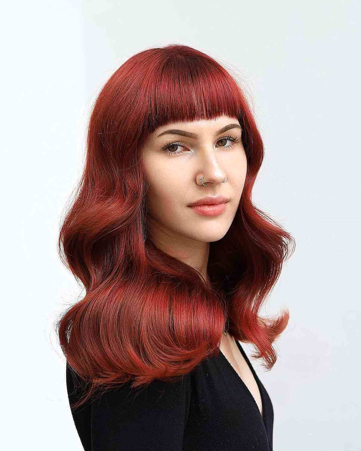 wavy red hair with blunt bangs