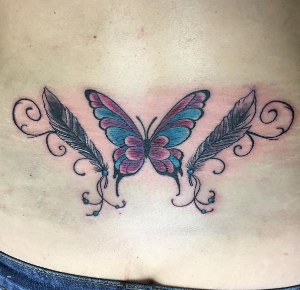 feather and butterly lower back tattoos