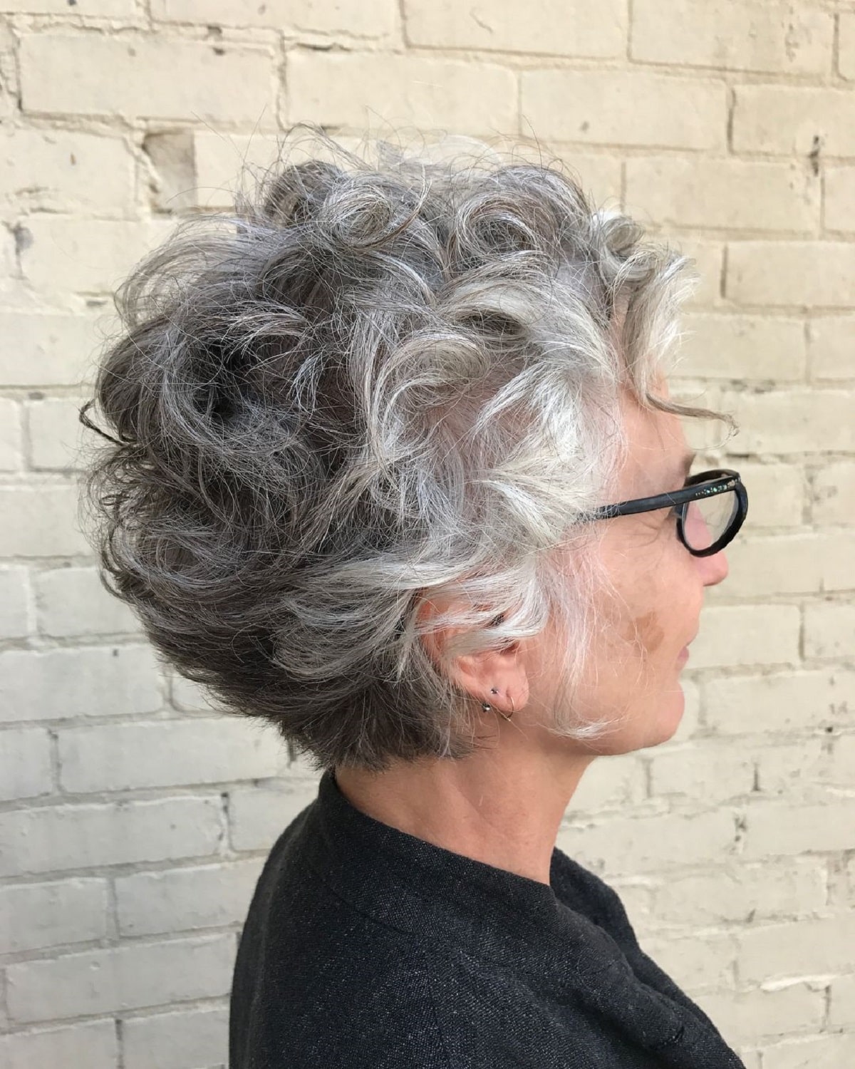 short curly hair pixie for older women wearing glasses