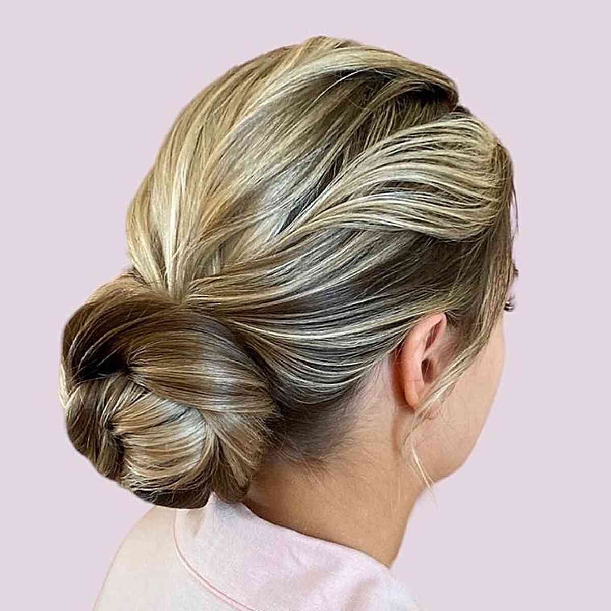 blown blonde low textured bun for wedding guest hair ideas
