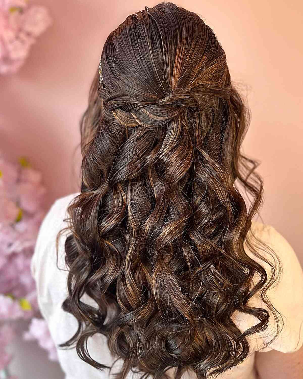 braided half up with voluminous waves as wedding guest hairstyle
