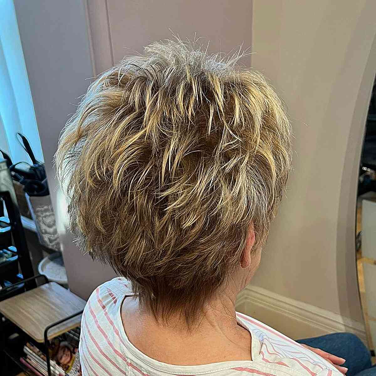 dark rooted blonde feathery choppy pixie for mature women aged sixty