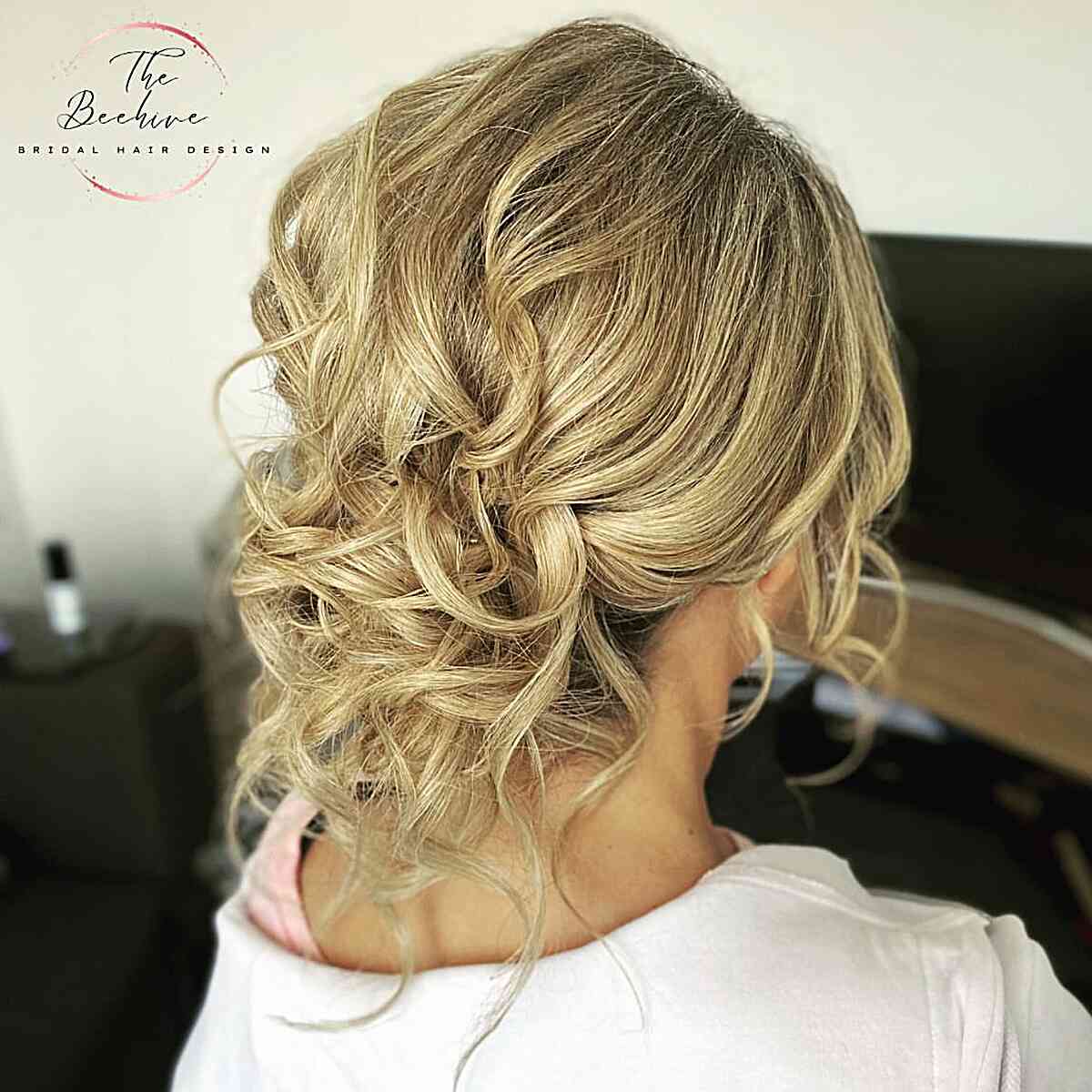 easy textured wavy low bun wedding guest hairstyle