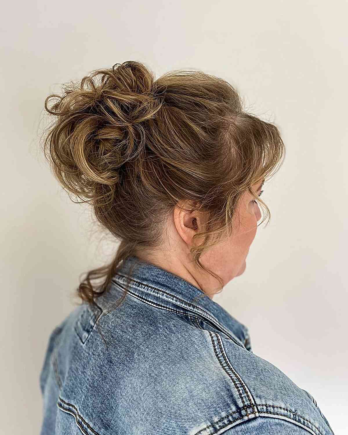face framing high loose knot hairstyle for older wedding guests