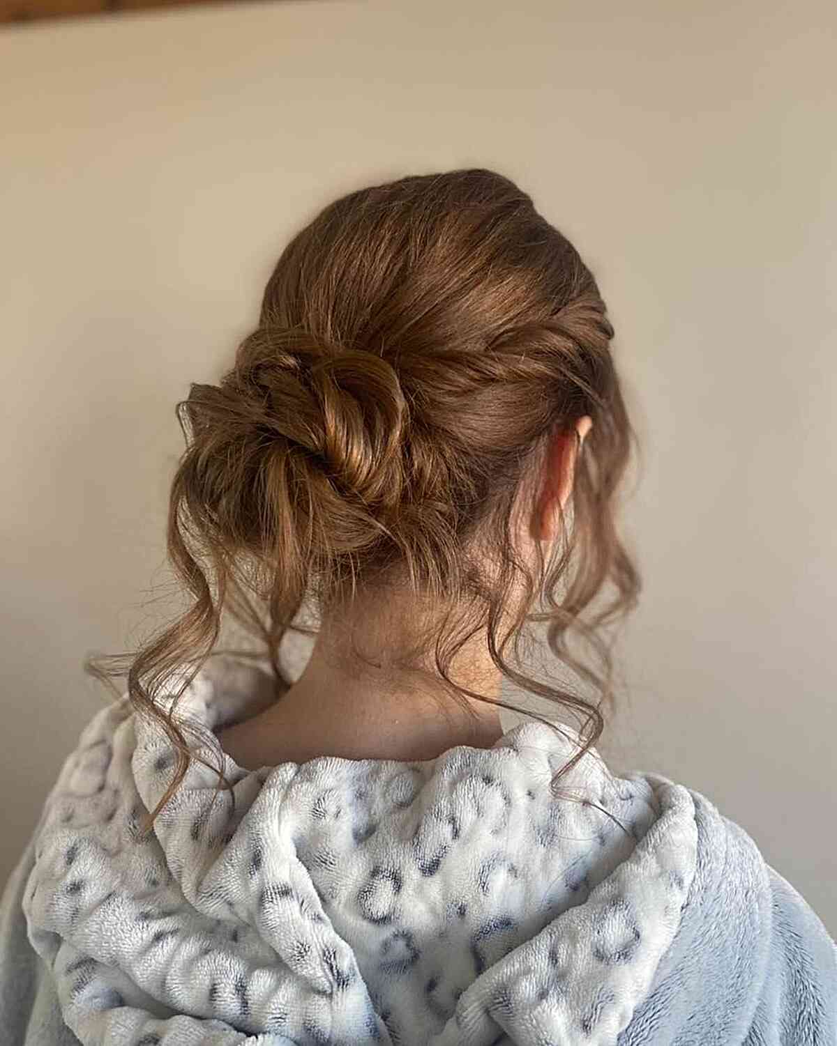 twisted updo with loose strands for girls graduation