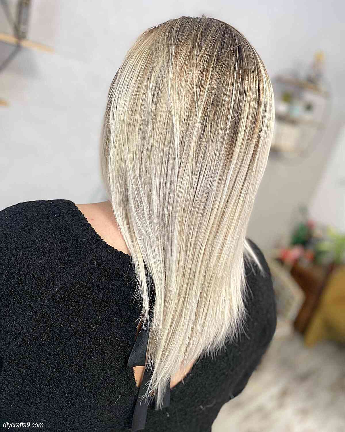brown rooted champagne blonde balayage with straight layers