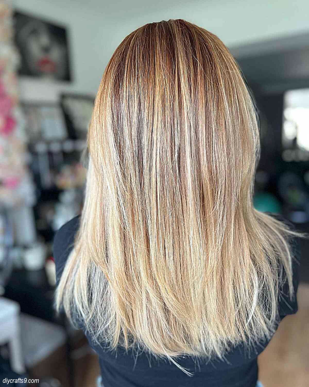 buttery blonde straight balayage hair with copper roots