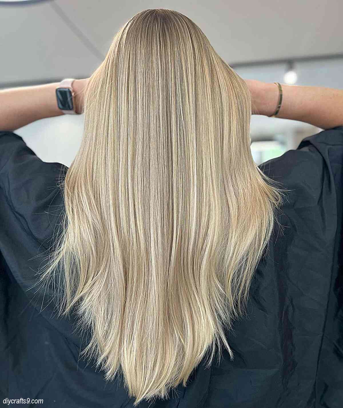 cool blonde balayage hue with straight v shaped cut