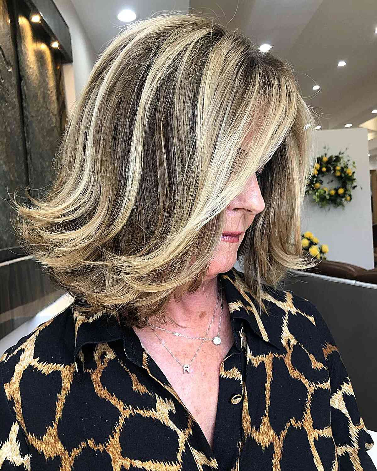 dimensional blonde brown hair with feathered ends for women over sixty