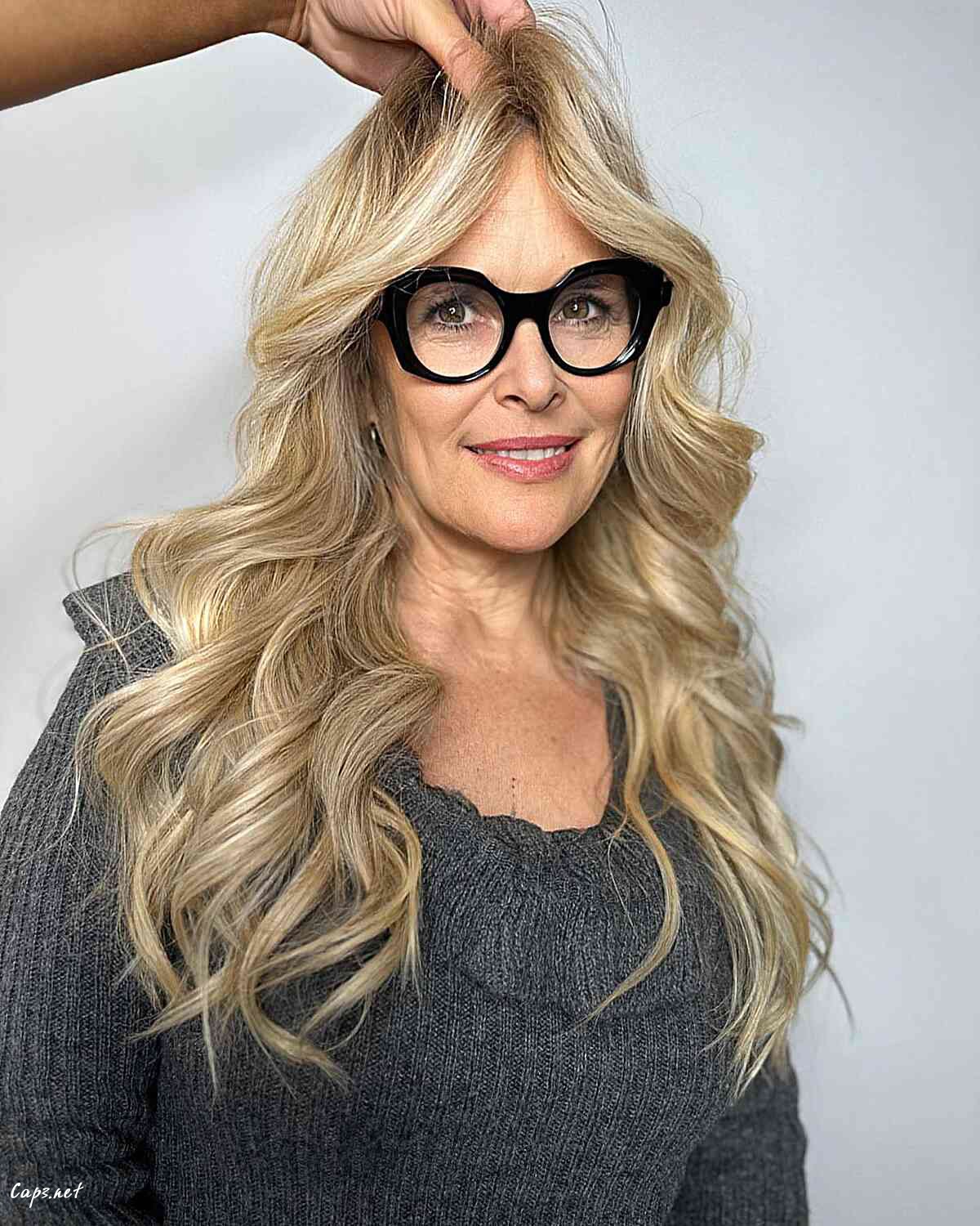 sandy blonde balayage with voluminous waves for older women over sixty