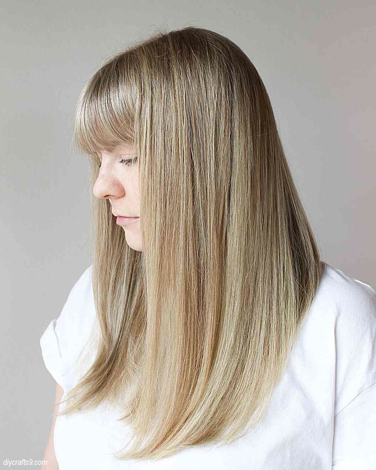 straight blonde balayage hair with bangs and shadow root
