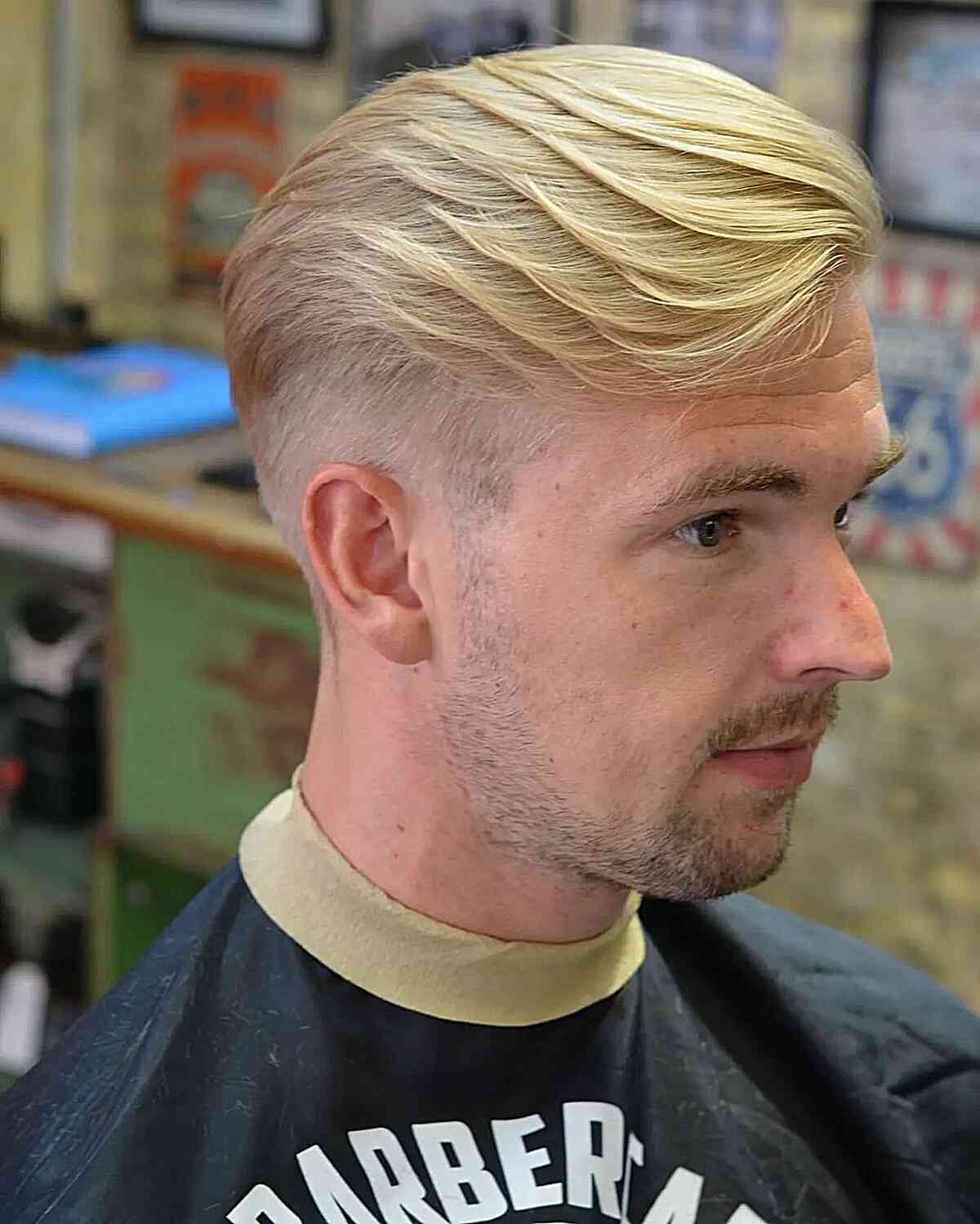 layered blonde hair with a taper fade for men