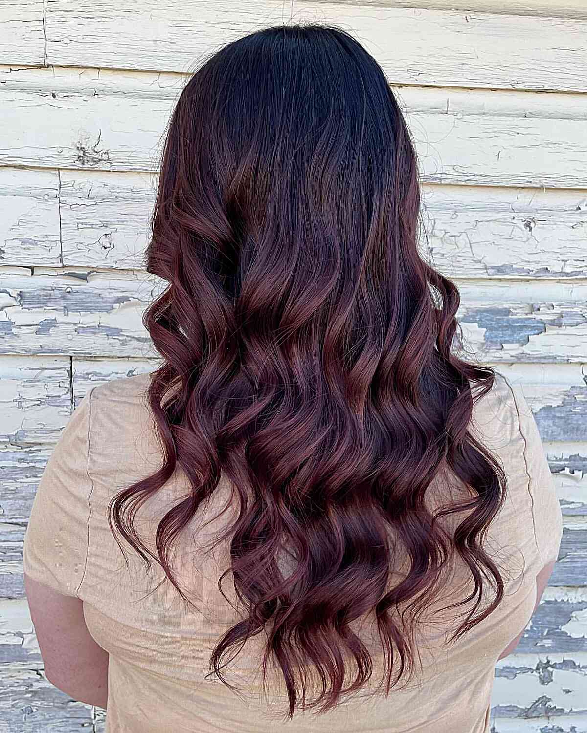 loose curls with mahogany and burgundy balayage tones