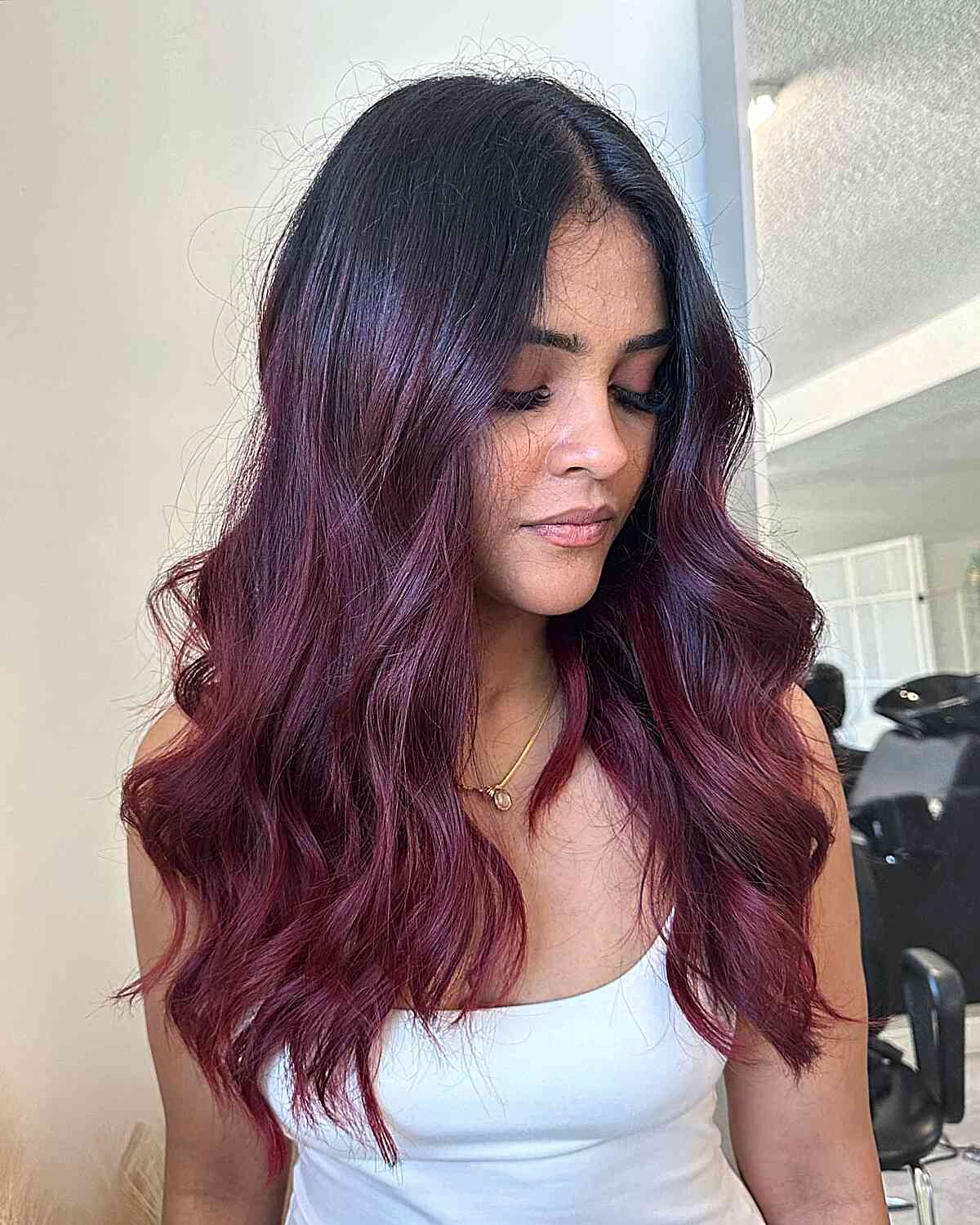 muted burgundy balayage waves with middle part