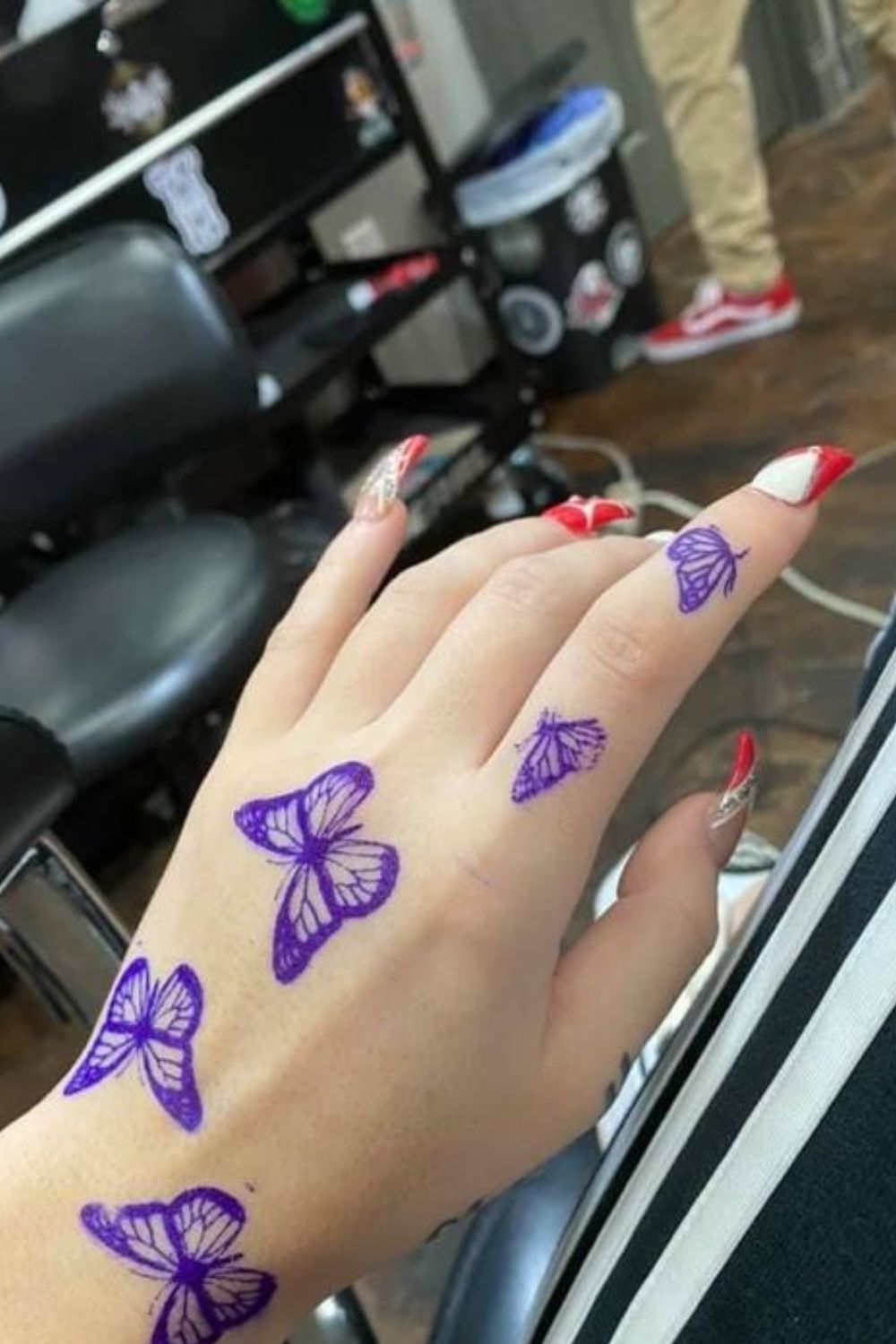 Whimsical Butterfly Hand Tattoo